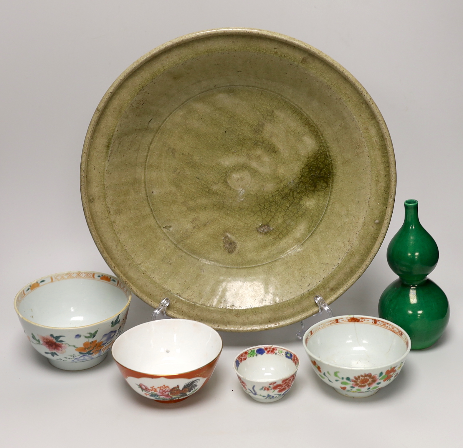 A Thai Sawankhalok celadon dish, 35cm, four rice and tea bowls and a double gourd vase